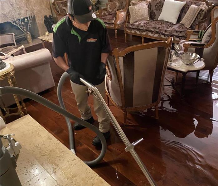 Male using equipment to cleanup water damage 