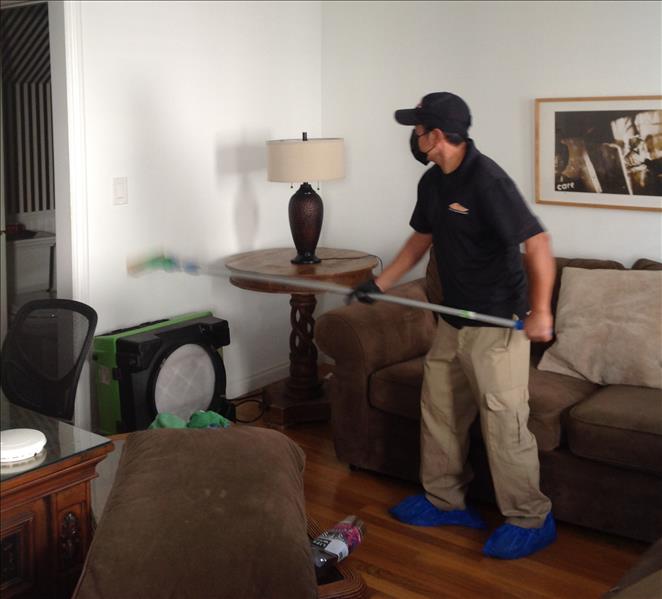 male wearing black shirt cleaning walls with a machine