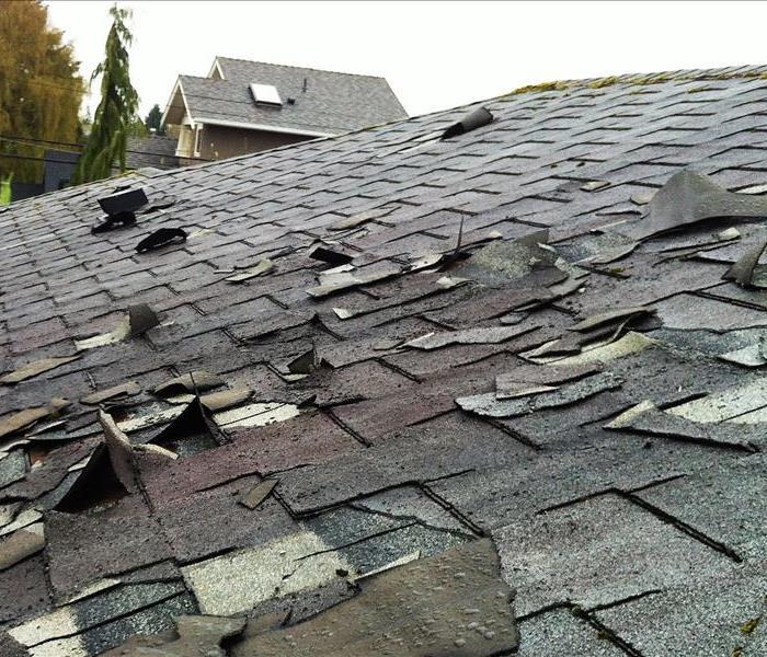 roof top after storm damage with tiles falling off 