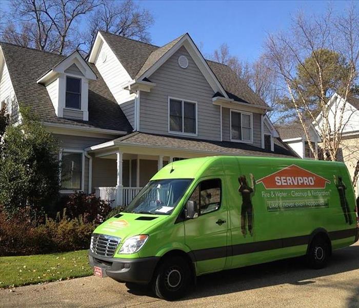 green servpro van in front of white house 